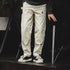 Men’s retro workwear off-white distressed loose fit jeans with multiple pockets.